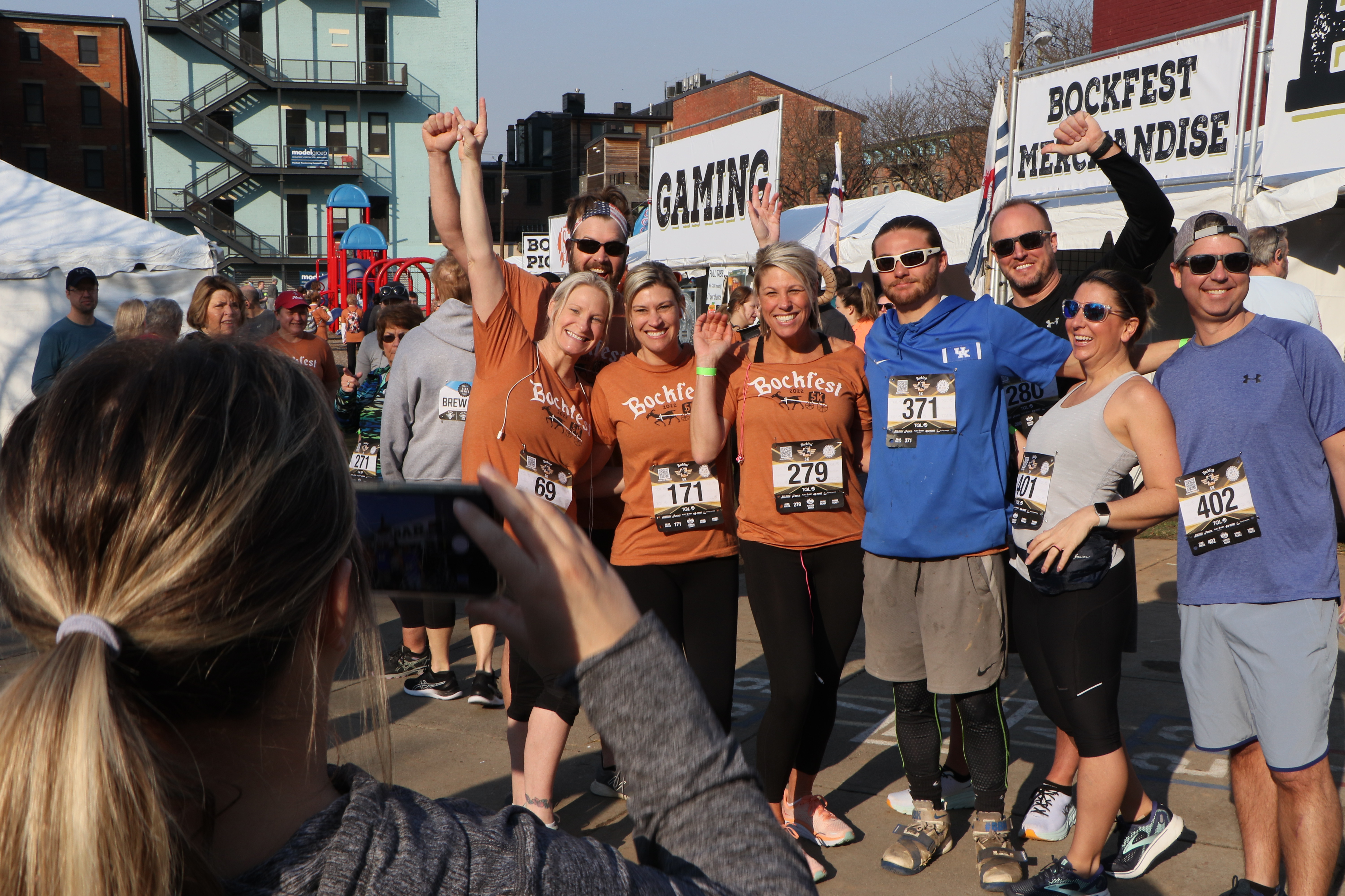 a group of participants posing for a photo in the midst of the post race party